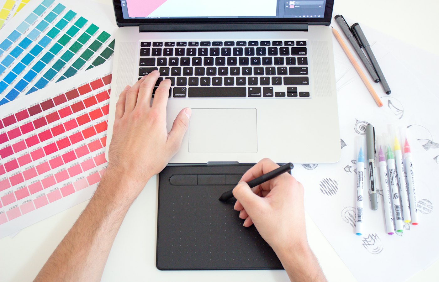 Graphic designer working with colour swatches and logo sketches